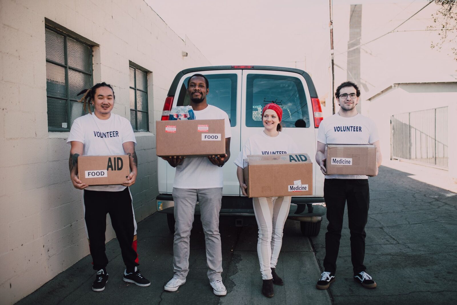 Volunteers carrying donation boxes together